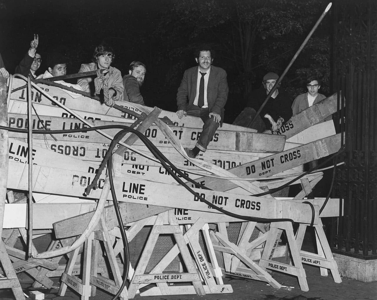 Protesters climbing police barricades at Columbia University (April 1968) (courtesy New York City Municipal Archives)