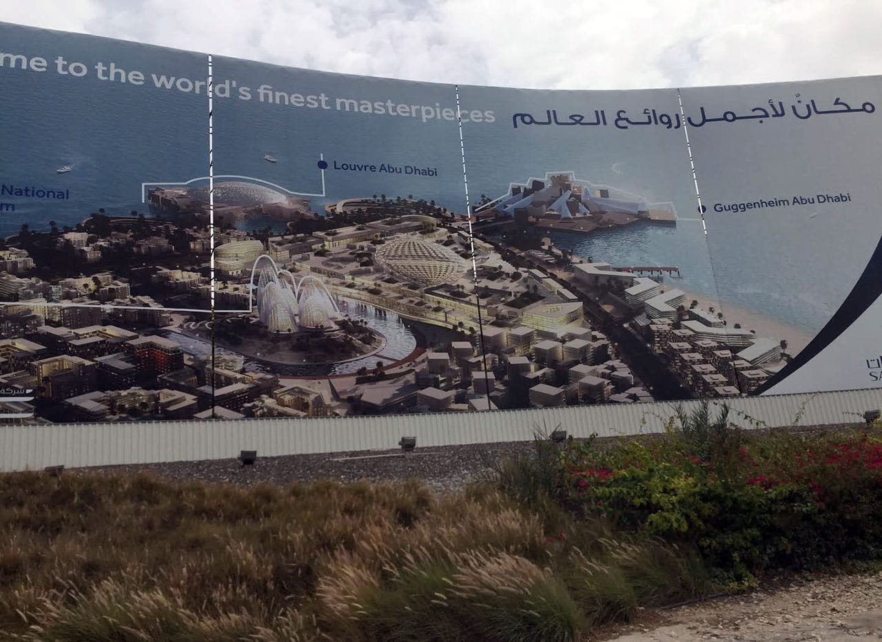 A billboard on Saadiyat Island, Abu Dhabi, advertises several of the museum projects as The World's Finest Masterpieces. (photo by the author for Hyperallergic)