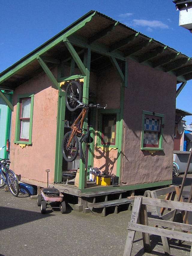 This adobe structure is one of several tiny houses built in Dignity Village, a homeless community in Portland, Oregon that was one of the earliest tiny house villages when it opened in 2001. The 120-square-foot space is constructed from mud and straw and clad in weatherproof adobe. 