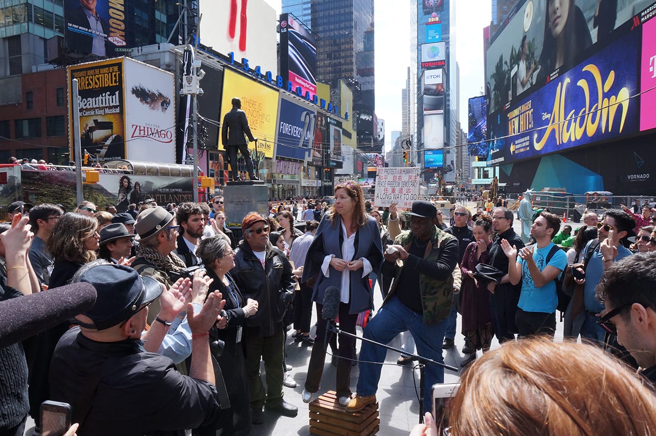 Creative Time President Anne Pasternak speaking at "#YoTambienExijo: A Restaging of Tatlin’s Whisper #6" in Times Square (all photos by the author for Hyperallergic)