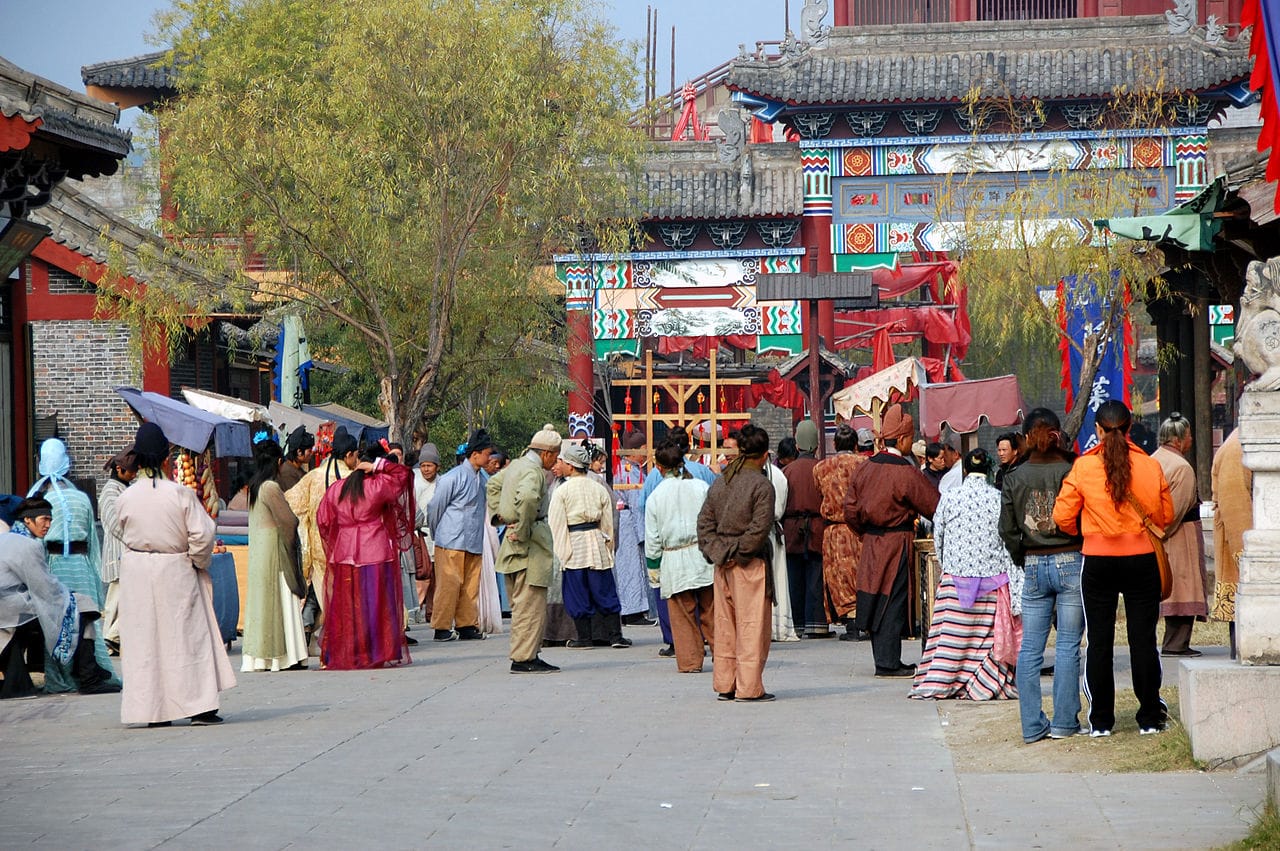 Tourists and costumed performers at Hengdian World Studios (photo by kanegen, via Wikimedia Commons)