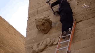 A member of ISIS destroying a sculpture at Hatra (gif by the author for Hyperallergic)
