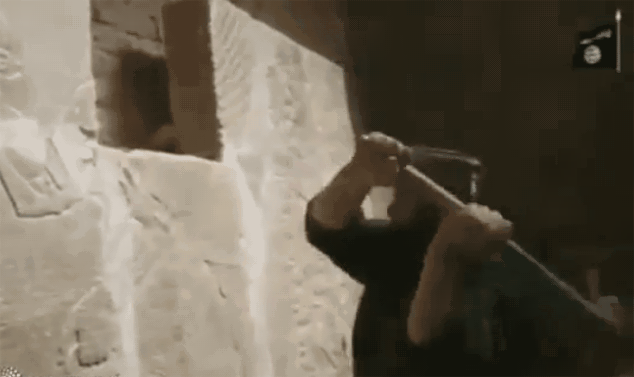 Video by ISIS of a militant destroying an ancient Assyrian frieze. (Screen grab via Youtube)