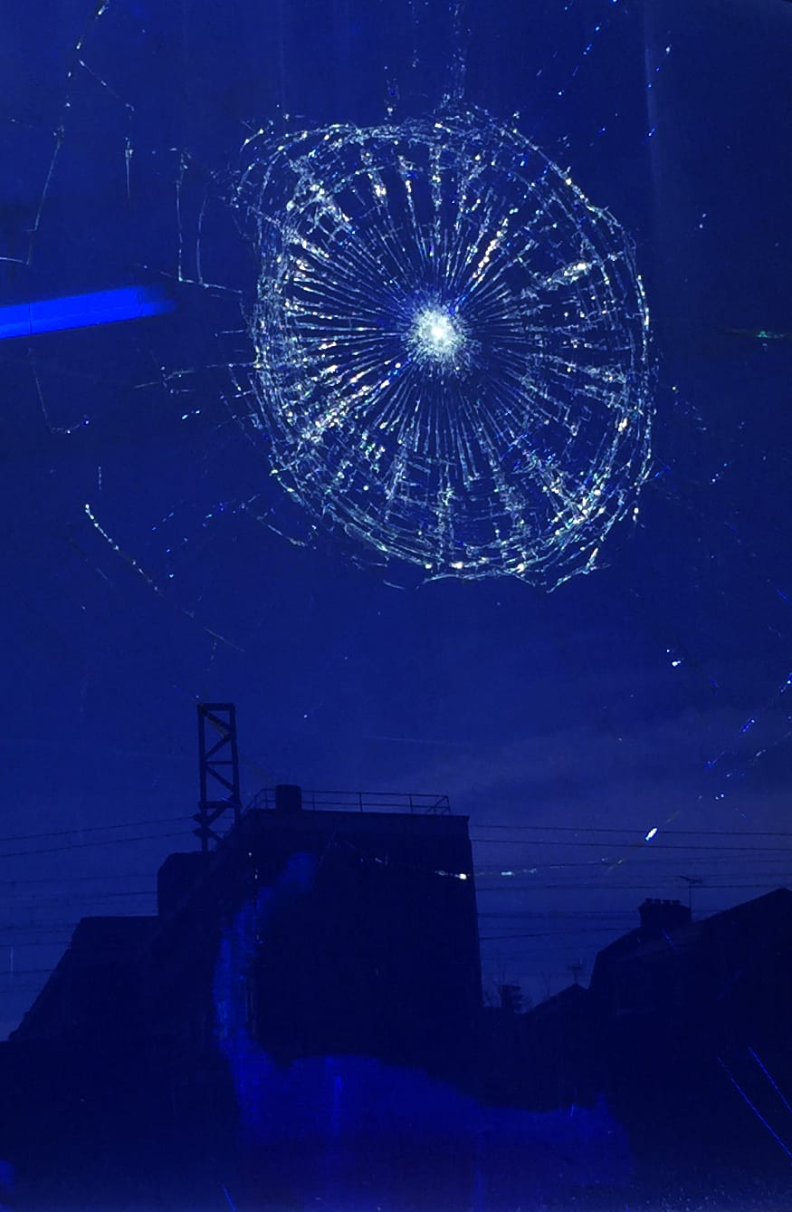 Smashed window resembling one of Morris' reoccurring motifs, the spider web. 