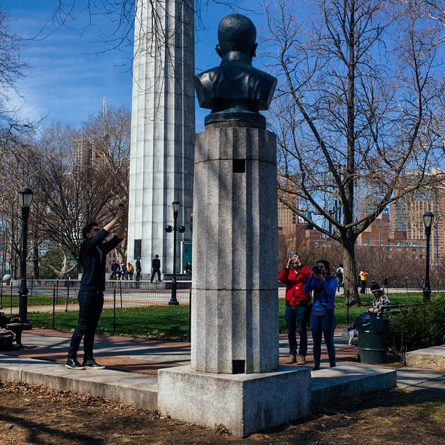 Park-goers photographing the bust of Edward Snowden in Fort Greene Park (photo by Jon Pack/Flickr)