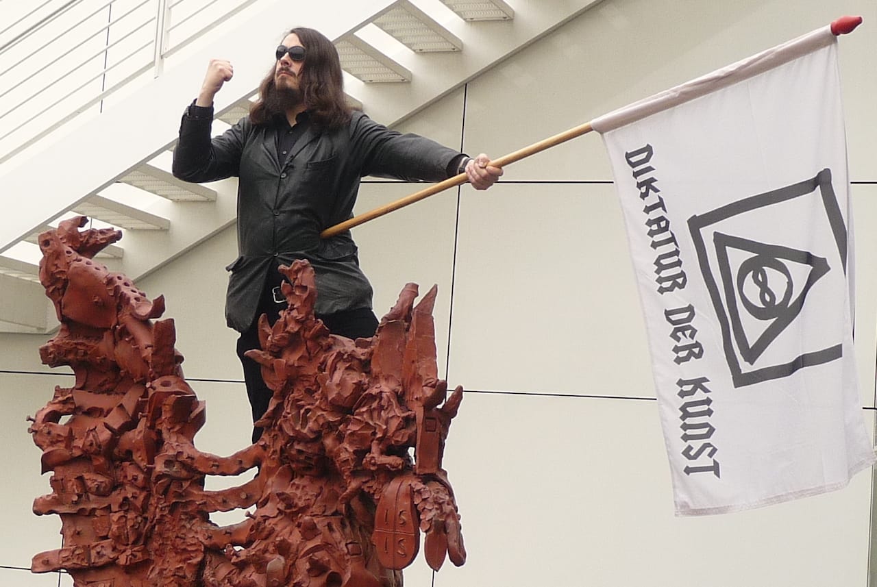 Jonathan Meese performing at the Arp Museum Bahnhof Rolandseck in 2009. (photo by Warburg, via Wikimedia Commons)