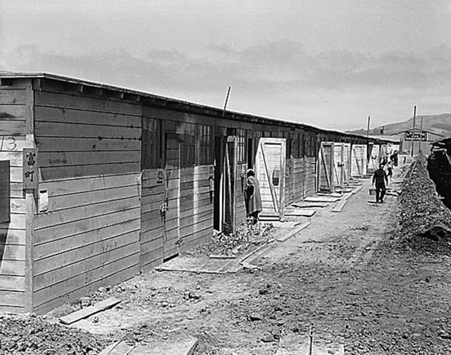 San Bruno, CA, June 16, 1942. Barracks at Tanforan Assembly Center, the site of a former racetrack. The camp had been open for about six weeks (Photographed by Dorothea Lange, WRA / Courtesy of the National Archives and Records Administration via Densho.org (National Archives Identifier 537919))