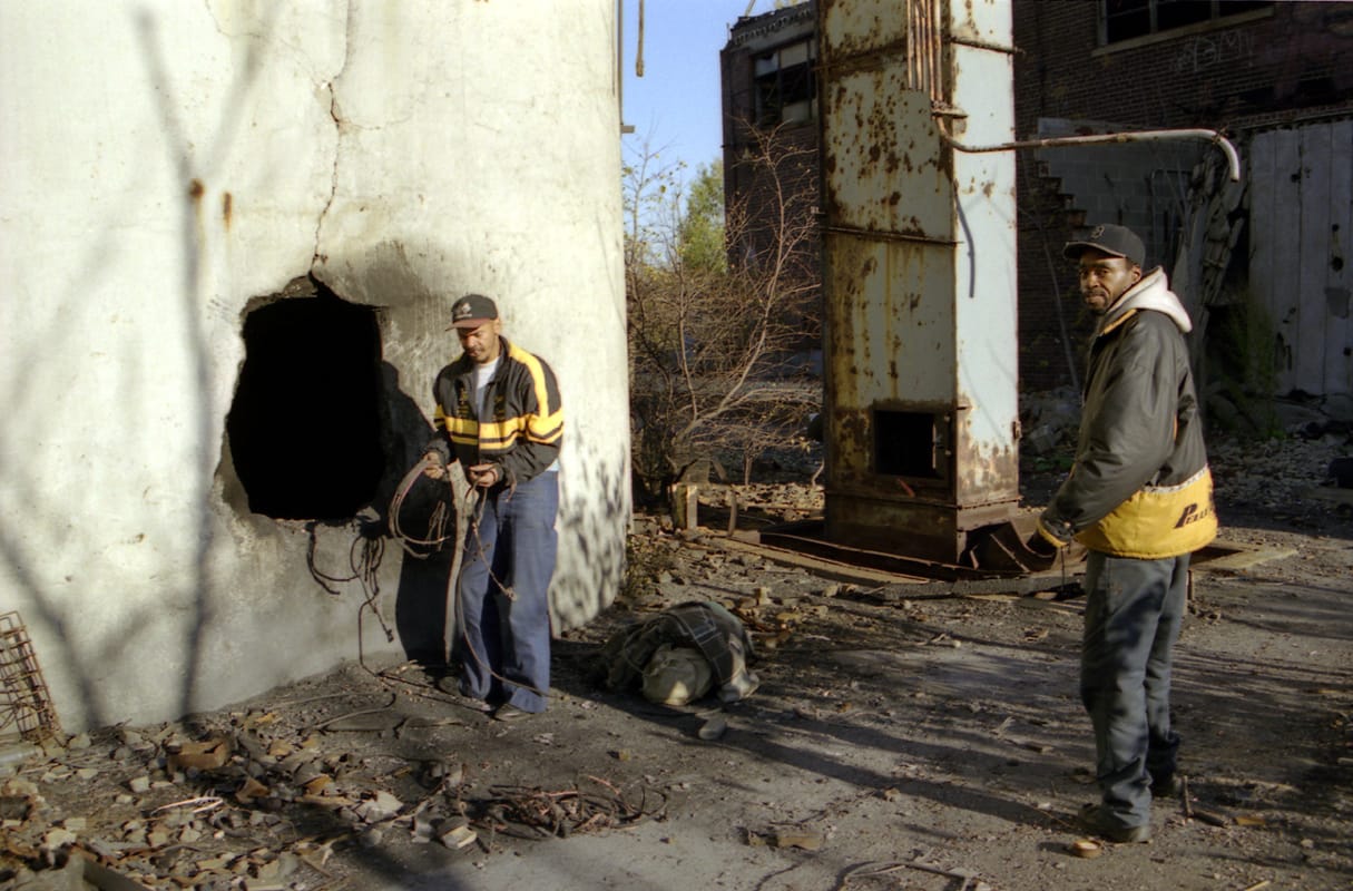 An image from Hocking's 'Scrappers' series: Stacy and JA stripping copper wiring