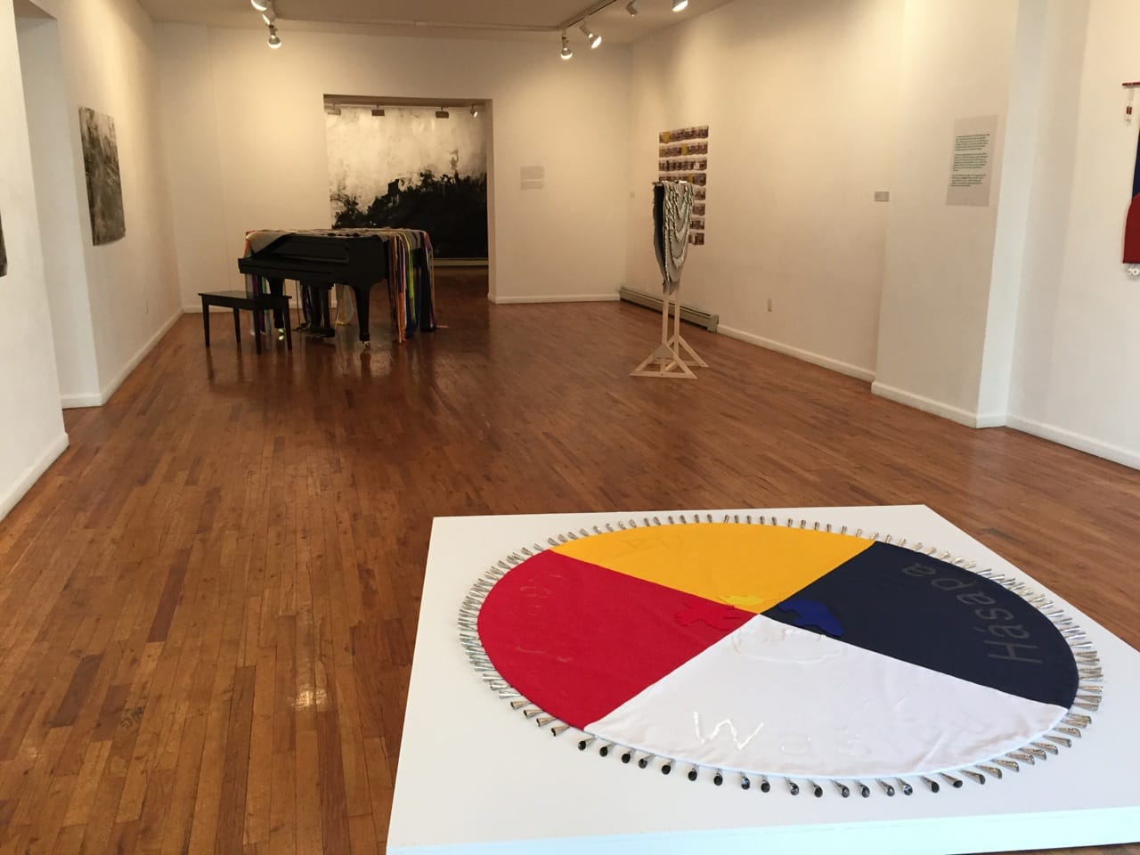 Installation view of 'How to catch eel and grow corn' at Wilmer Jennings Gallery, with a mandala by Maria Hupfield in foreground (all photos by the author for Hyperallergic)