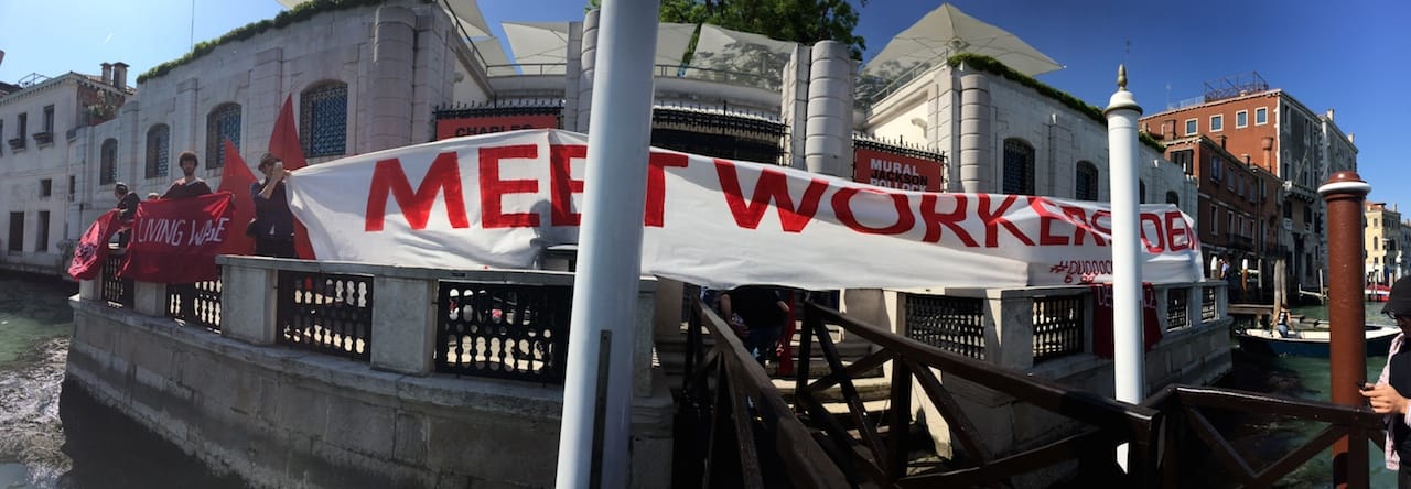Members of Gulf Labor occupy the Peggy Guggenheim Collection in Venice with a banner that reads "Meet Workers' Demands" (all photos by the author for Hyperallergic)