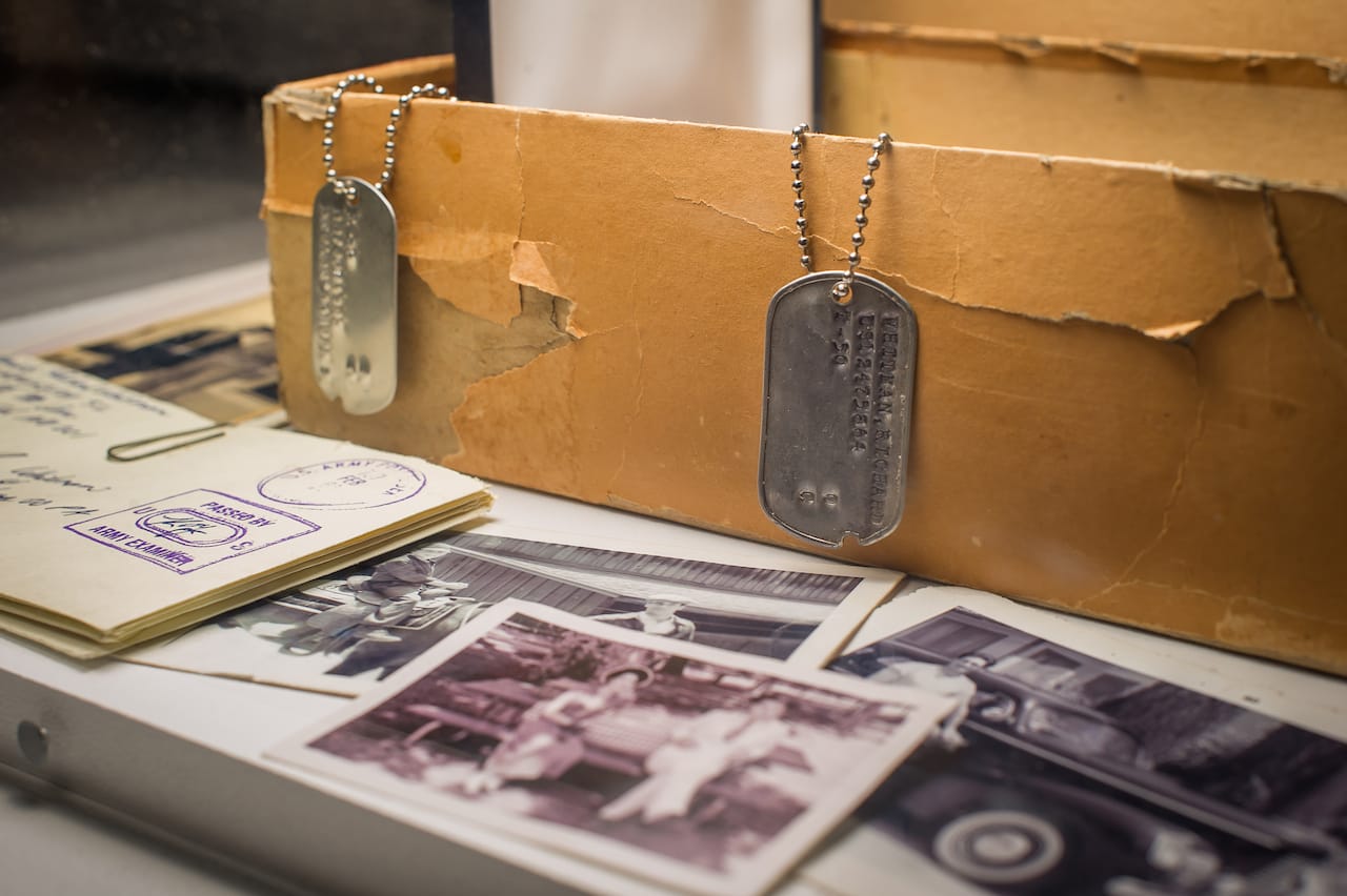 New York - March 10, 2015. At the Museum of the Moving Image press preview for the exhibition "Matthew Weiner's Mad Men." Detail: Don Draper's box of secrets revealed. Shown: Dick Whitman's dogtag, letters, and family photos. Photo: Thanassi Karageorgiou / Museum of the Moving Image.