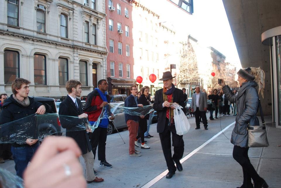 Former Cooper Union board of trustees chairman Mark Epstein walking past protesting students in 2012 (photo by Free Cooper Union, via Wikimedia Commons)