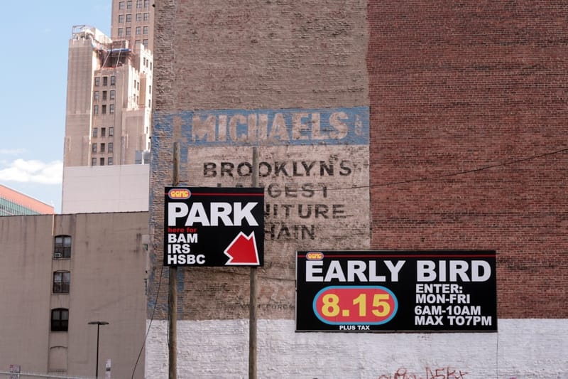 A ghost sign and new parking signs in New York City