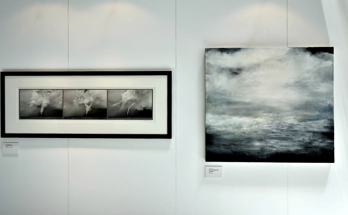 Mitch Dobrowner, "Tornado Triptych," pigment ink on cotton rag; M'Liz Keefe, "Northern Atlantic from Fogo Island," oil on canvas (photo by the author for Hyperallergic)