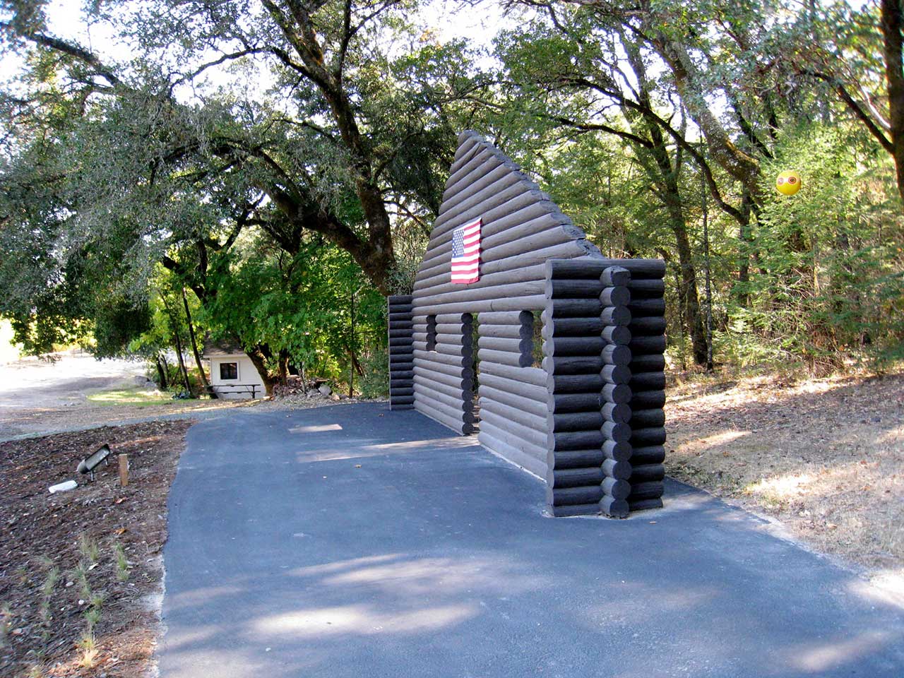 Cady Noland's "Log Cabin Blank With Screw Eyes and Cafe Door (Memorial to John Caldwell)” at Stonescape in California. (image courtesy flickr.com/msippey and used with permission)