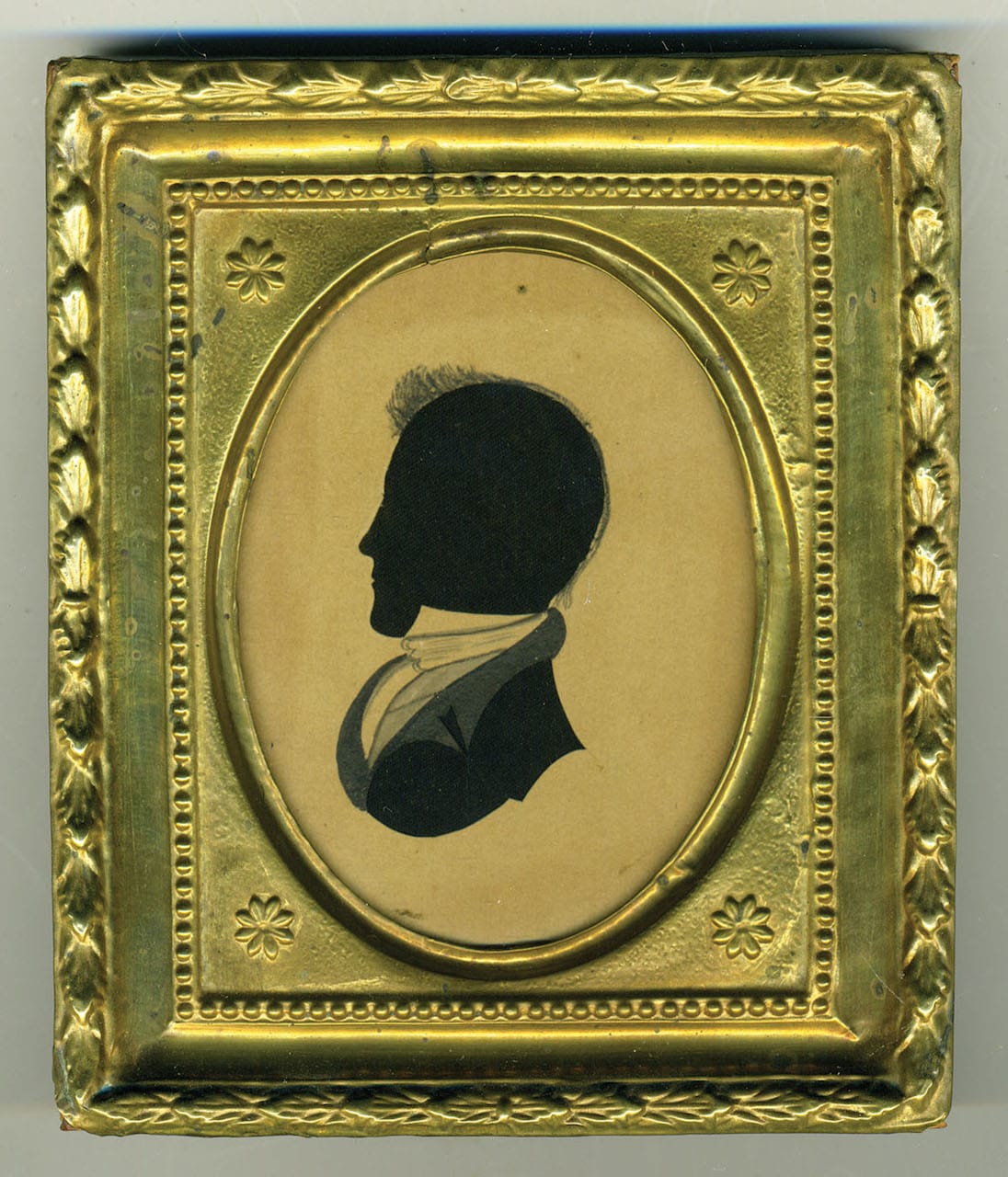 Part of a pair of 19th-century hollow-cut silhouettes showing a woman and gentleman on black silk, with watercolor bodies, in gilt repousse frames, both attributed to the so-called "Dash Artist" 