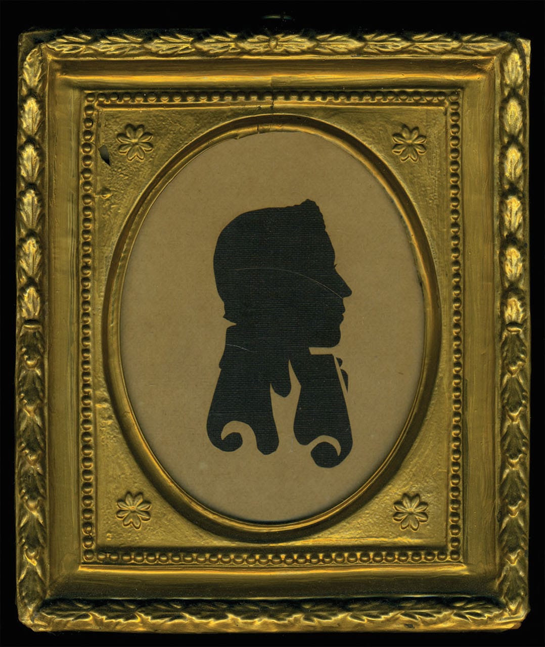 Hollow-cut silhouette, early 19th century, of a gentleman with curlicue cut outs of jacket, attributed to E. Howard