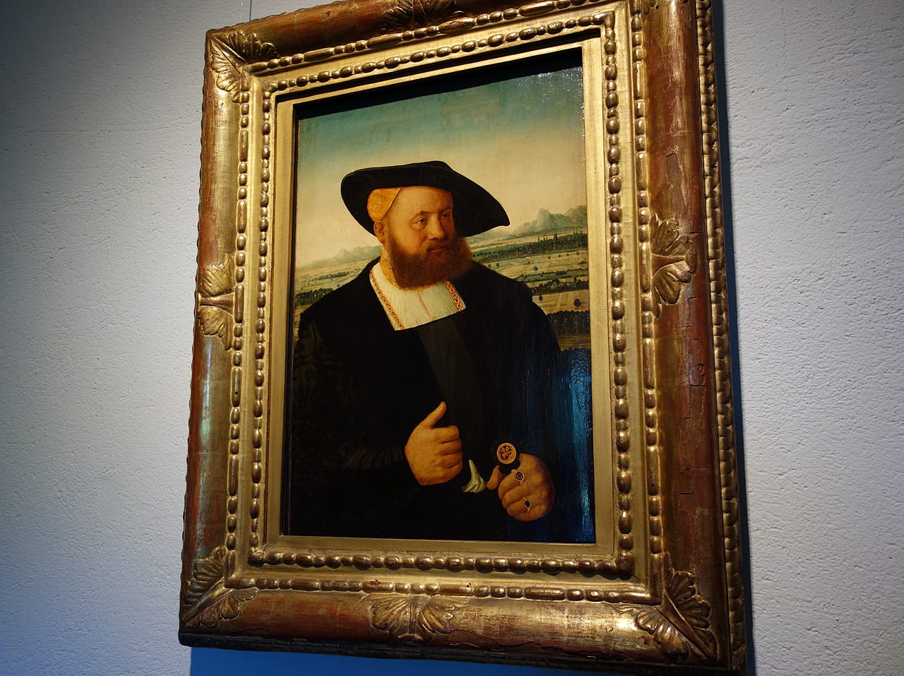 Conrad Faber von Creuznach, "Portrait of a Man with a Moor's Head on His Signet Ring" (1530s), oil and gold on wood