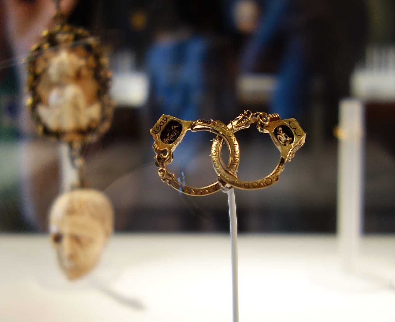 Renaissance Gimmel ring with memento mori (German, 1631), gold, enamel, diamond, ruby. The ring separates into two parts with secret spaces revealing a baby on one side and a skeleton on the other. An inscription states: "Whom God has joined together, let no man tear asunder."
