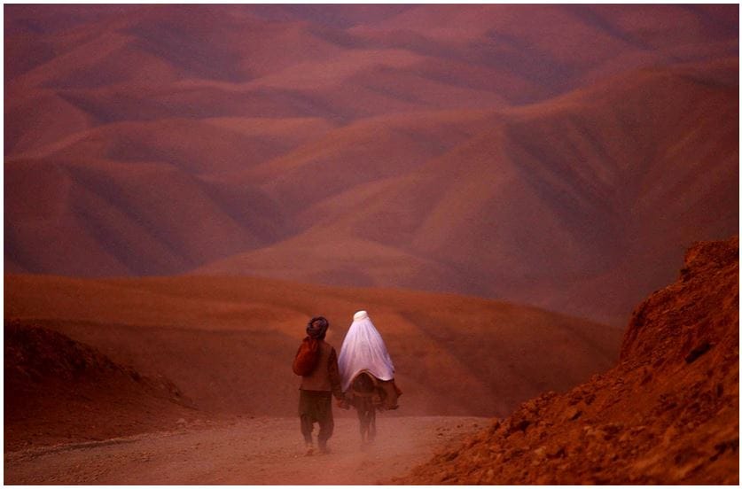 James Hill. A couple went down the barren roads of Badakhshan province, North Afghanistan, 2001