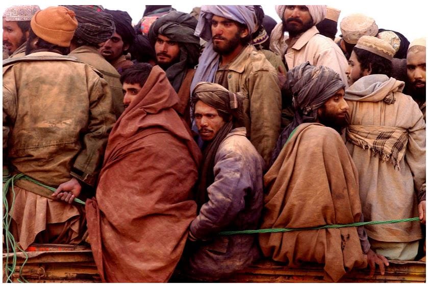 James Hill. Taliban prisoners squeezed onto a truck in the desert, North Afghanistan, November 2001