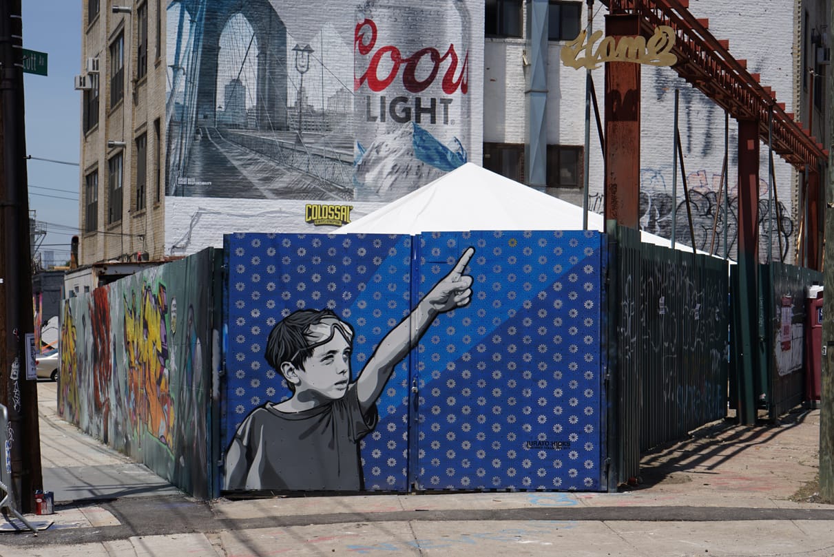 A Bushwick Collective mural by Joe Iurato at Troutman Street and St Nicholas Avenue with a large Coors billboard in the background. (photo by Joe Iurato, courtesy the artist)