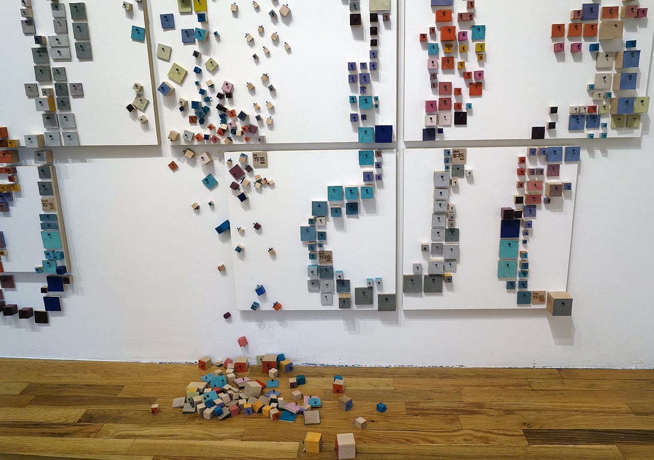 Laurie Frick, "14 Days" (2015), wood block, tacks, leather on wall, and canvas primed panels, 108 x 168 inches; 14 days of time-use tracking, color coded by activity