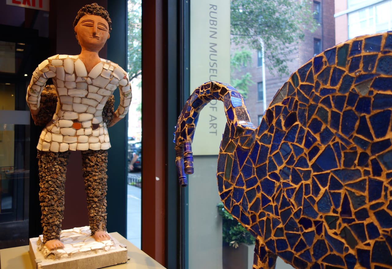 Nek Chand, "Boy with Back Basket, Ceramic Shirt, Clinker Legs" (1984-85), concrete, ceramic; Nek Chand, "Blue Glass Animal" (1984-85), concrete, ceramic, glass