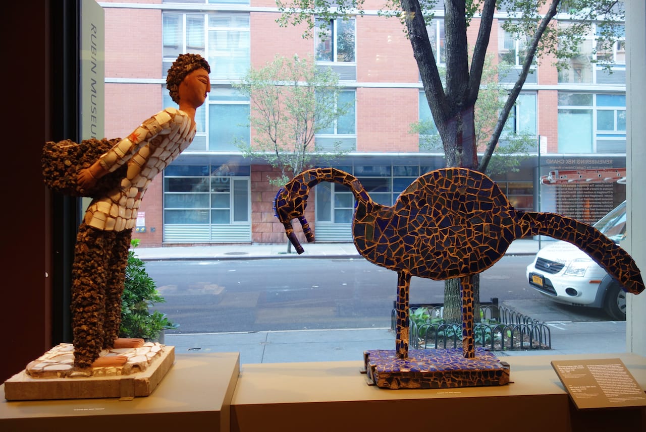 Nek Chand, "Boy with Back Basket, Ceramic Shirt, Clinker Legs" (1984-85), concrete, ceramic; Nek Chand, "Blue Glass Animal" (1984-85), concrete, ceramic, glass