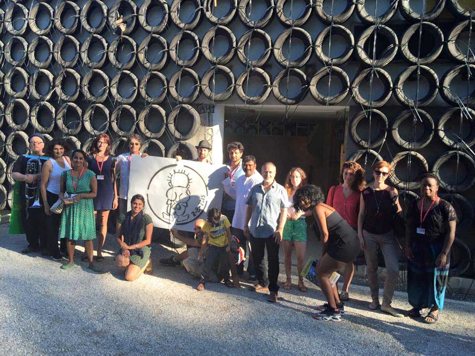 The "Occupying" group outside the Israeli Pavilion at the 2015 Venice Biennale. The tires on the outside of the pavilion are part of artist Tsibi Geva's Archeology of the Present exhibition.