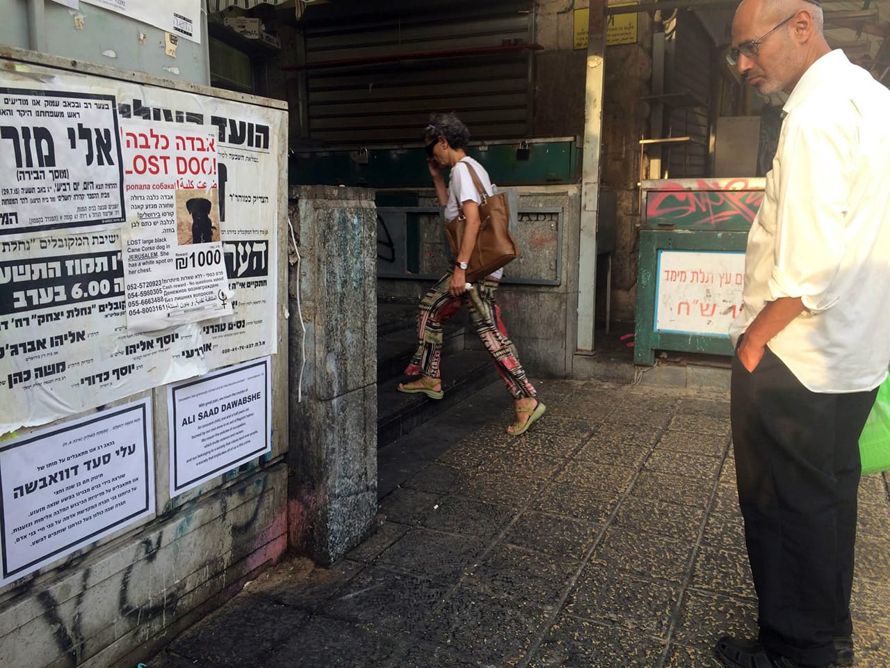 A man in Jerusalem reading one of the posters.