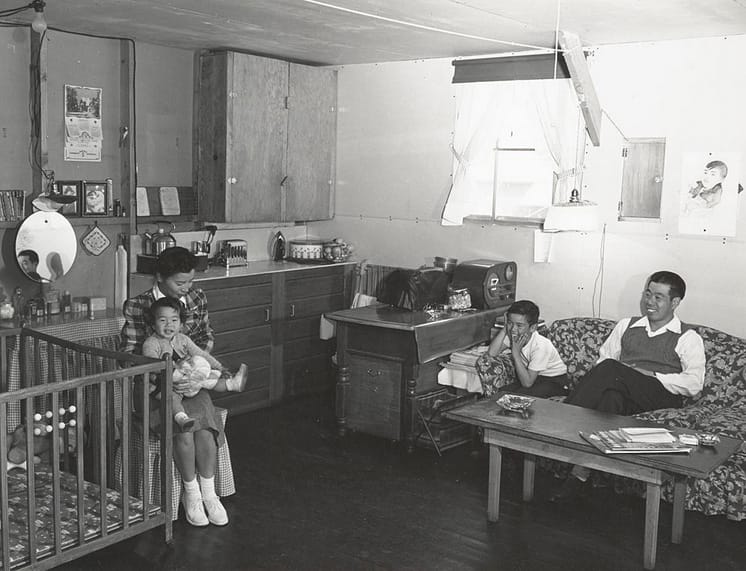Ansel Adams, "Manzanar, CA, 1943" (1943). The Izunos in their combined living room and kitchen area (photograph by Ansel Adams, courtesy the Library of Congress, Prints & Photographs Division [reproduction no. LC-DIG-ppprs-00238])