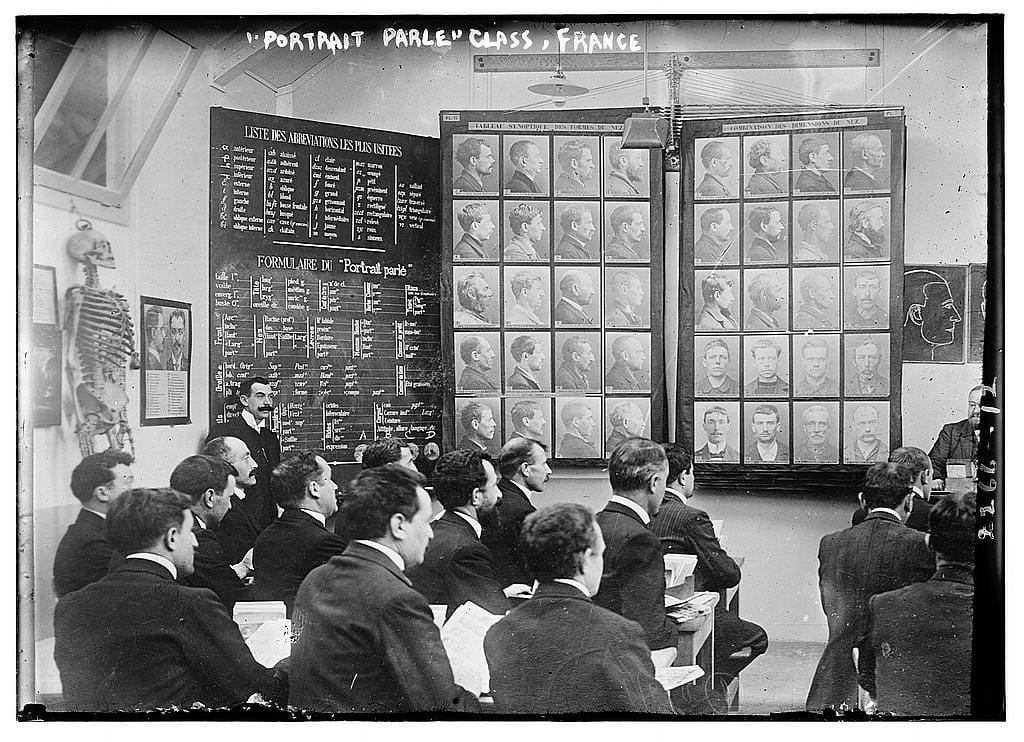 A class in Paris between 1910 and 1915 studying the Bertillon method of criminal identification, developed by the French criminologist Alphonse Bertillon. (photo by Bain News Service, via Wikimedia Commons)
