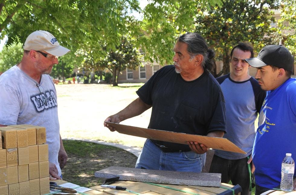 Jesús Moroles at center, working on Coming Together Park with faculty and students at USAO