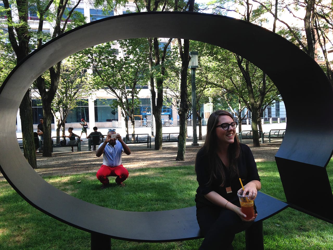 Hank Willis Thomas taking a photo of the crowd gathered at his preview, with curator Andria Hickey sitting on the bench