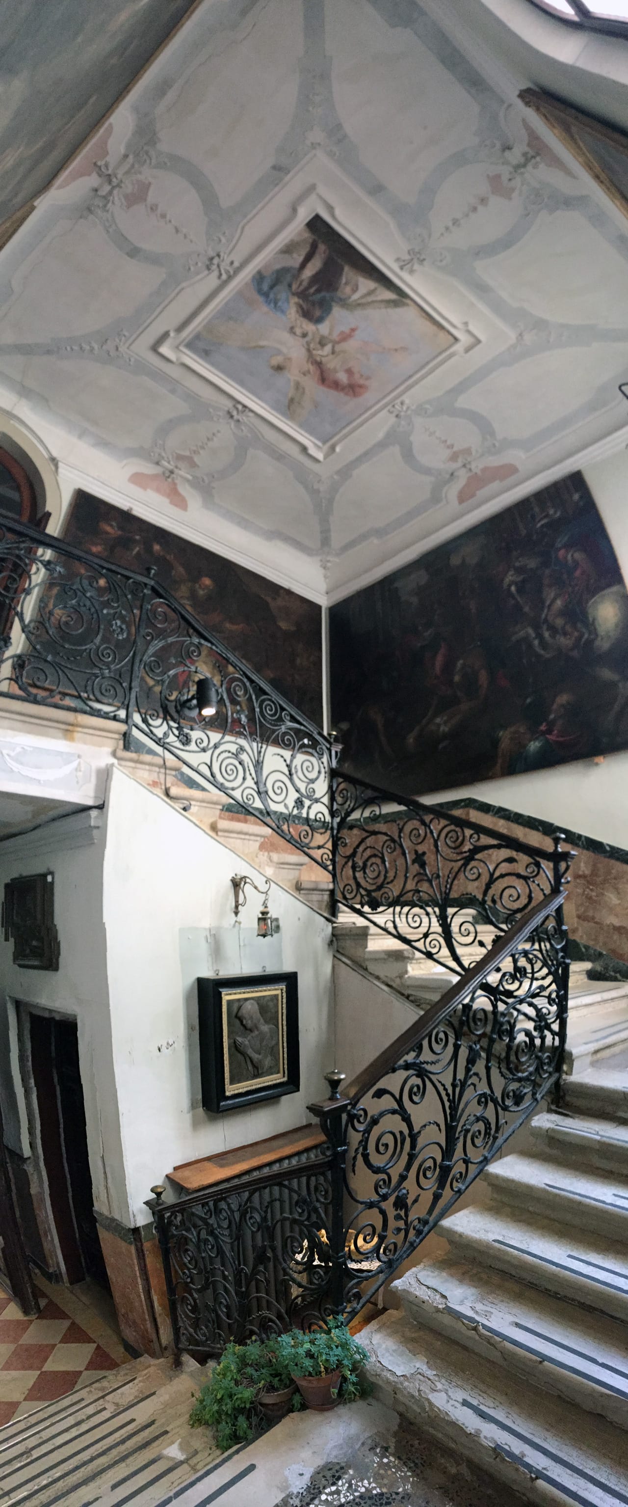 One of the central staircases of San Lazzaro with a partially hidden work by Sarkis at the center by the foot of the stairs.