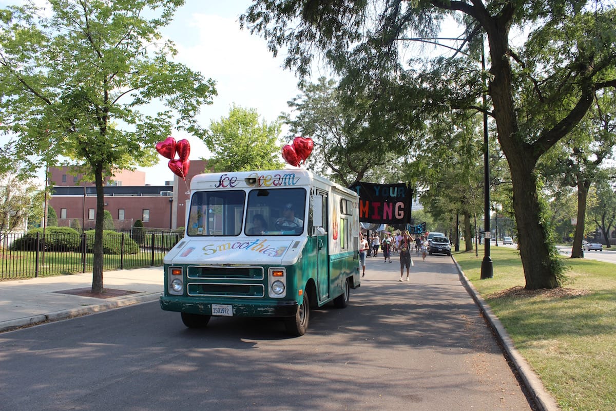 An ice cream truck leads the procession, giving out free ice cream to community members the procession passe