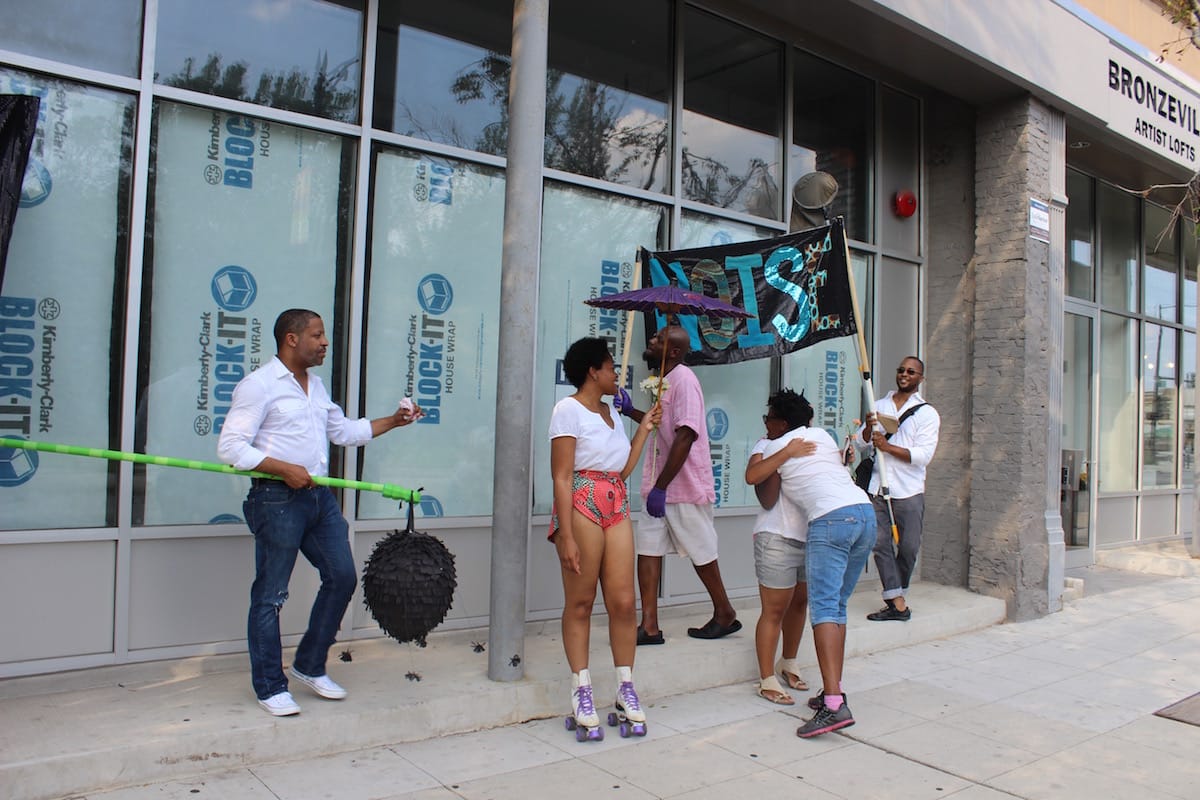Artists hug at the wrap of the procession (click to enlarge)