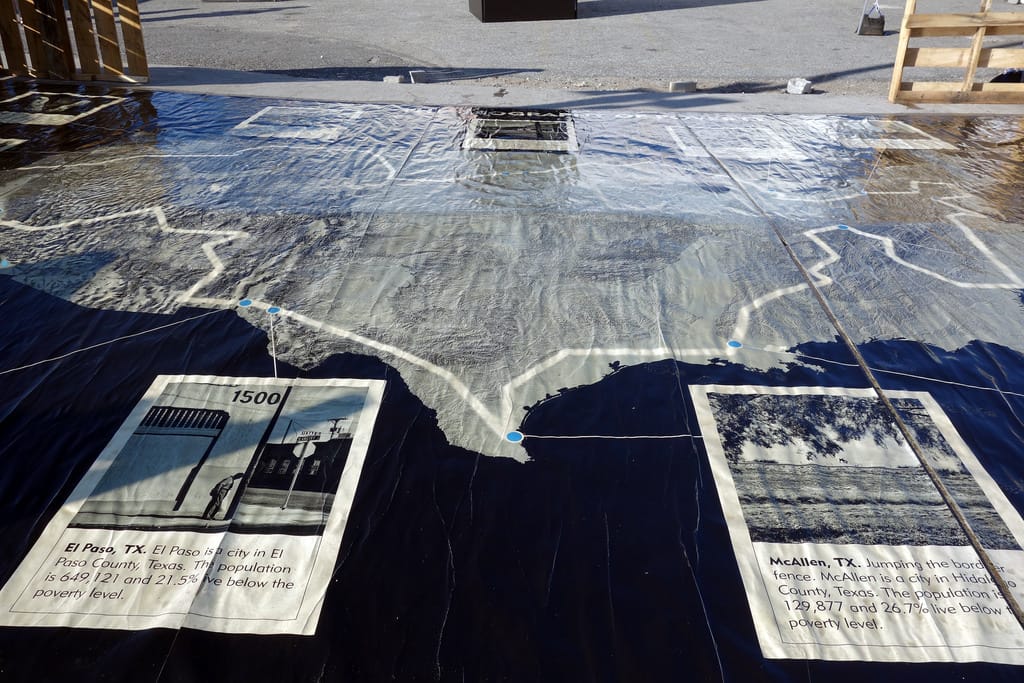 A map of 'Geography of Poverty' installed at Photoville in Brooklyn Bridge Park (photo by the author for Hyperallergic)