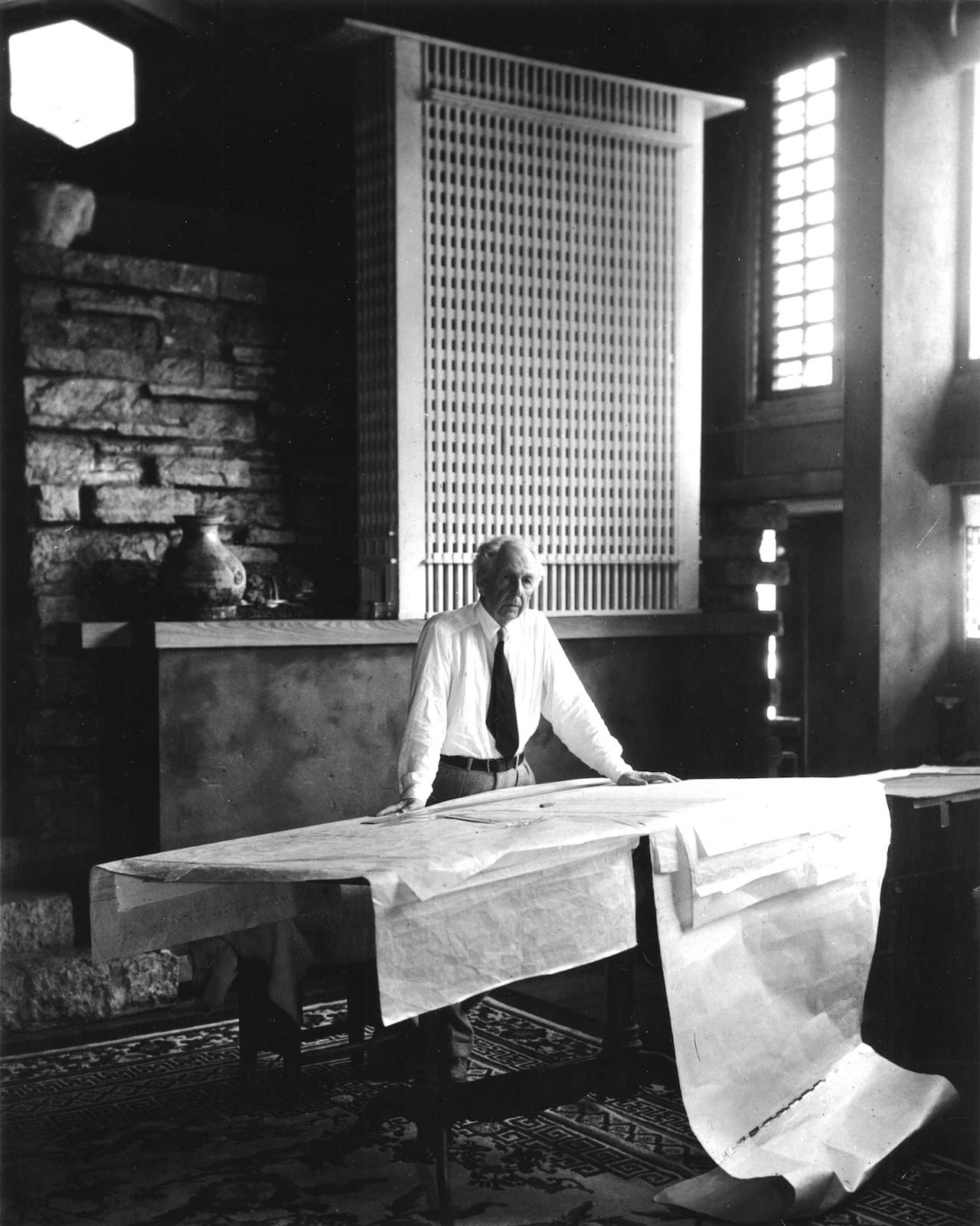 Frank Lloyd Wright stands at the drafting table in his studio at Taliesin, Wisconsin, 1947, photographed by Pedro E. Guerrero (© 2015 Pedro E. Guerrero Archives)