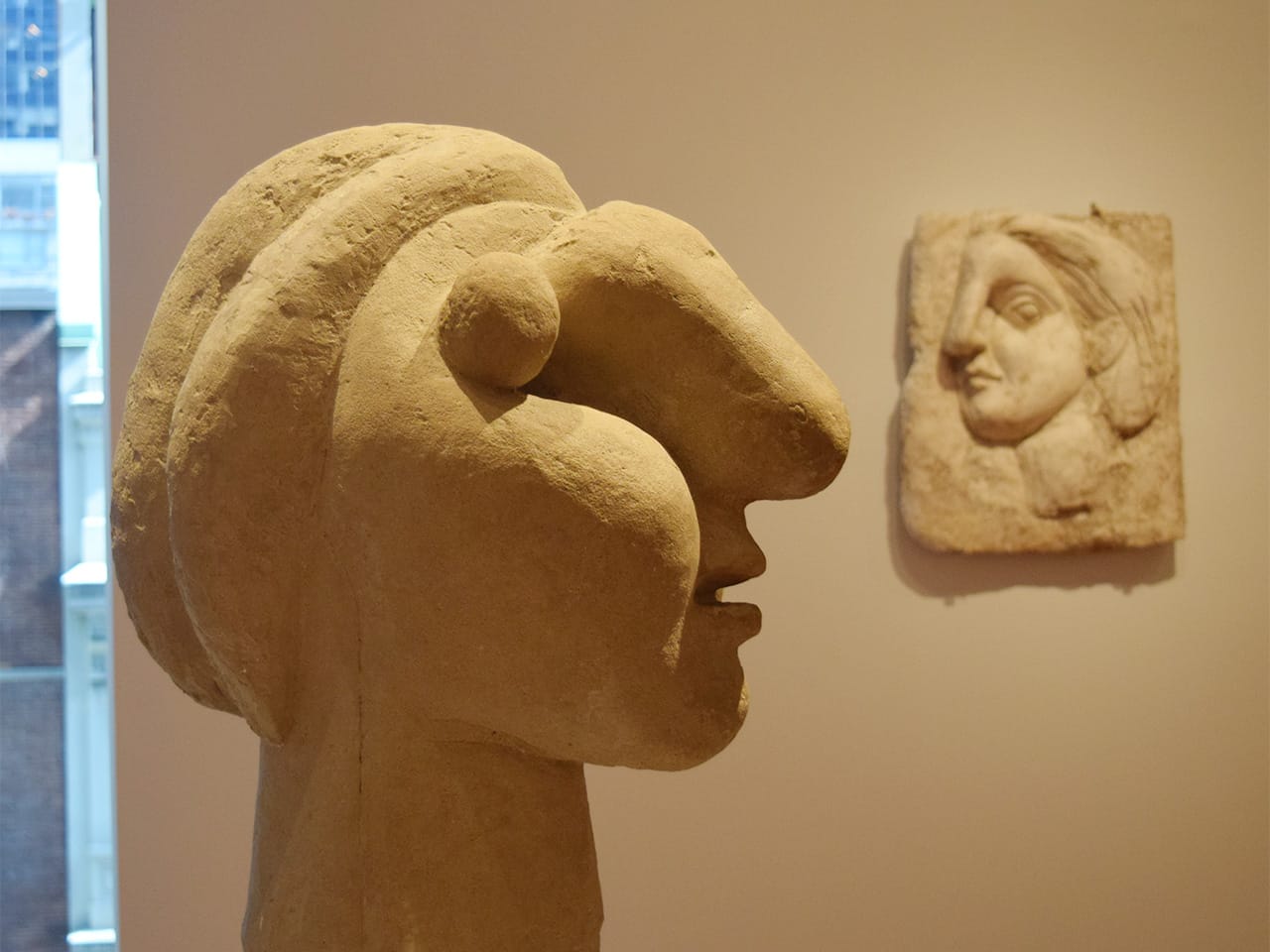 Installation view of 'Picasso Sculpture' at the Museum of Modern Art with Pablo Picasso's "Head of a Woman" (1931, cement) at left and "Head of a Woman" (1931, plaster) at right