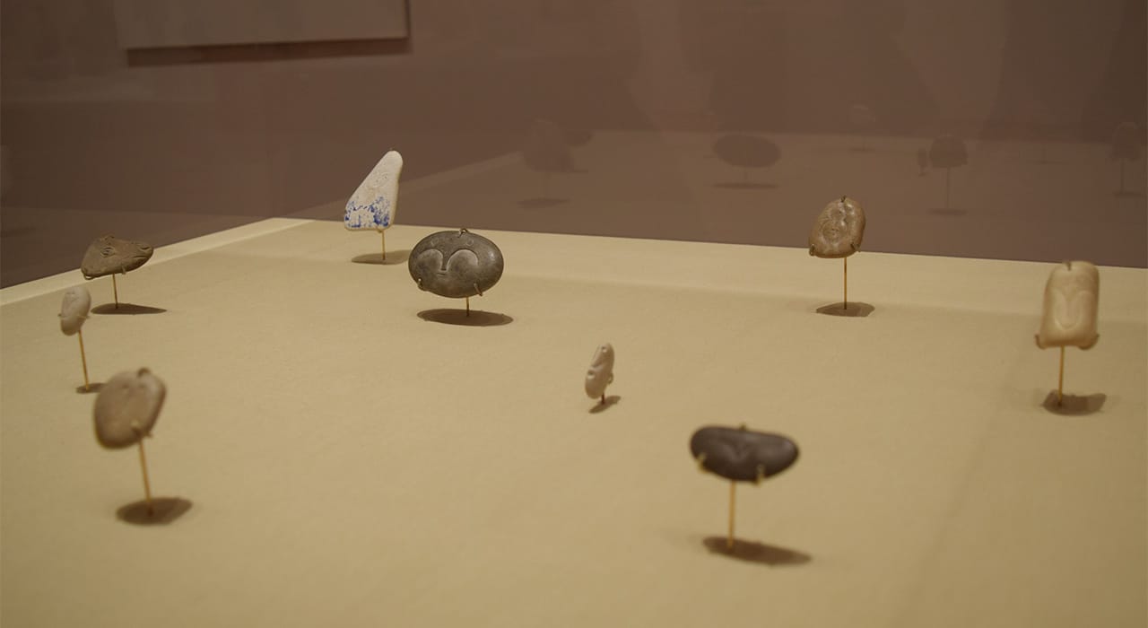 Installation view of Pablo Picasso's small engraved pebble and ceramic works in 'Picasso Sculpture' at the Museum of Modern Art