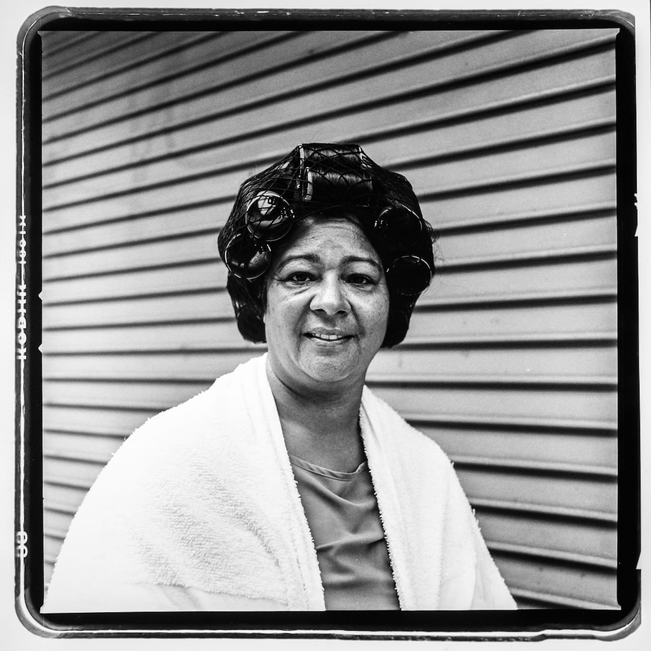 An unnamed client takes a cigarette break from the hair dryer at Bellissima Beauty Studio at 2175 Jerome Ave. Photo taken August 2015 by Melissa Bunni Elian/Bronx Photo League.