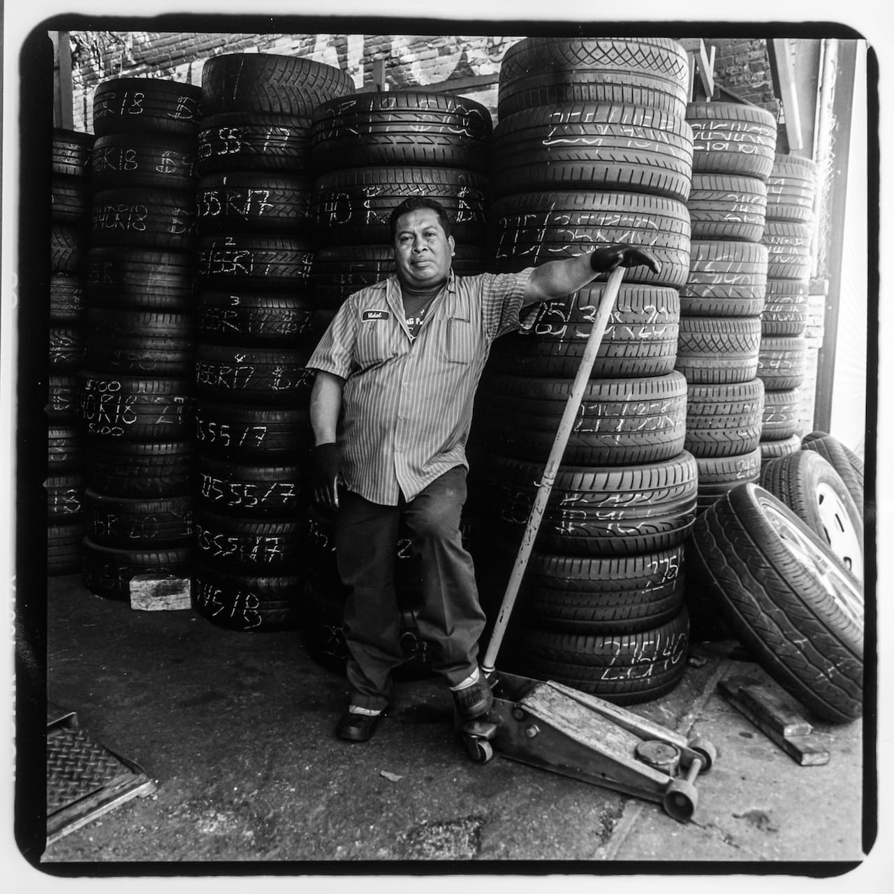 Josè Cruz, a mechanic at Diffo Auto Glass & Flat Fix, 1510 Jerome Avenue. Josè has been working on Jerome Avenue for 25 years--he fled the civil war in his native El Salvador in 1990. Photo taken June 27th, 2015 by David “Dee” Delgado and Michael Kamber/Bronx Photo League. 
