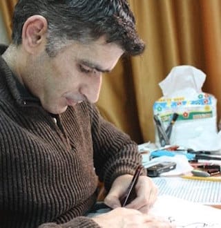 Syrian cartoonist Akram Raslan (Image via Facebook) 