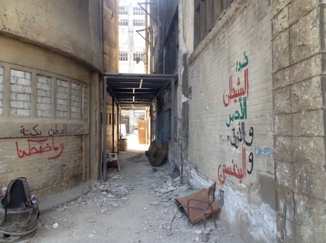 Right message: "Against the red, blue and purple devil" (Artists' note: "A Muslim Brotherhood reference made by an Egyptian general on Television in 2013"); Left: "Homeland is a joke, and it didn't make us laugh"