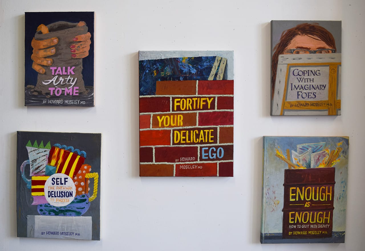 Paintings of satiric book covers in Paul Gagner's studio at 62 18th Street