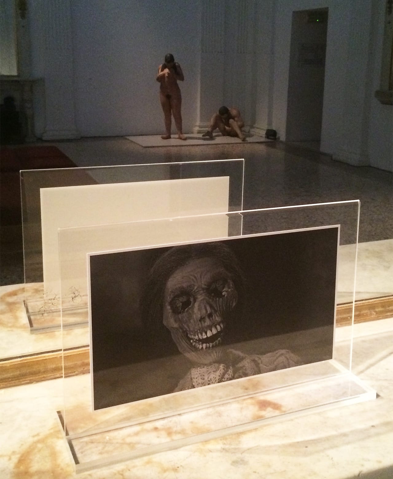 Installation view with a still from Alfred Hitchcock's 'Psycho' (1960) in the foreground and Kiki Smith's "Mother/Child" (1993) reflected in the mirror