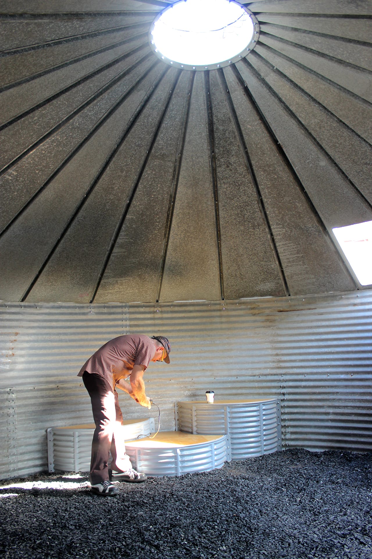 Jon Brumit plugs his phone in to activate the sound silo. Visitors can sub their own music players and experience them through the filter of the house. (click to enlarge)