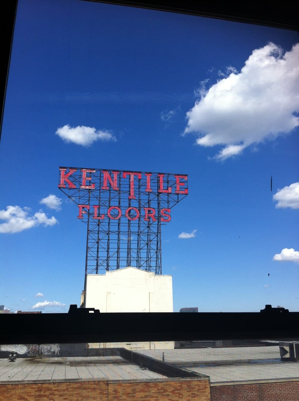 The Kentile Floors sign, which sat atop a building at the corner of 9th Street and Second Ave, was a longtime symbol of Gowanus. (photo by Hrag Vartanian/Hyperallergic)